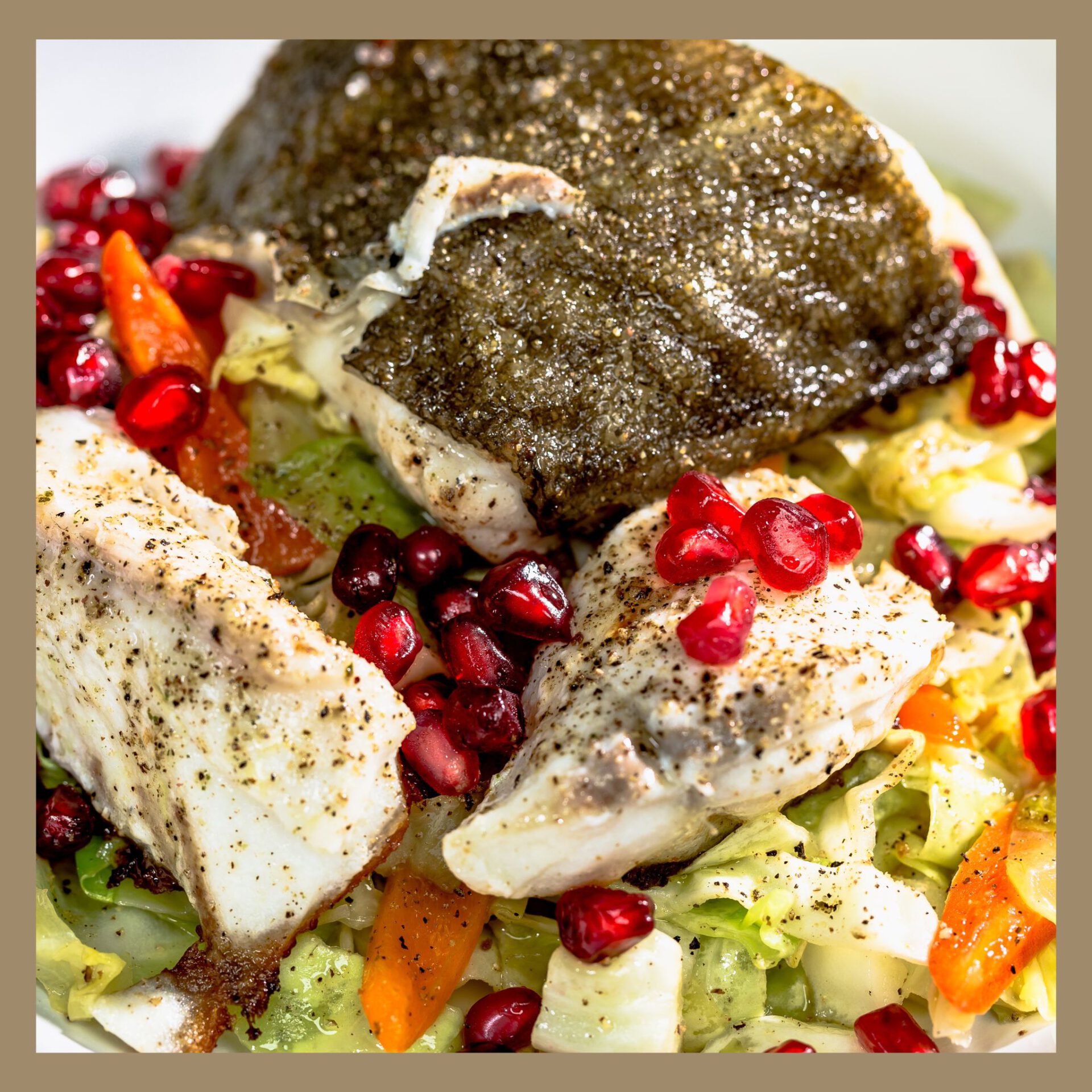 gebratenes Skrei Fischfilet auf Salat mit Granatapfelkernen
