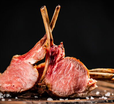 Rack of lamb grill on a cutting board.