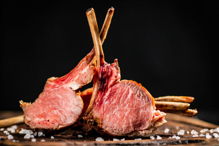 Rack of lamb grill on a cutting board.