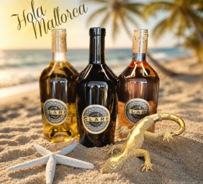 3 Flaschen Klari Weine im Sand mit Meer und Palme im Hintergrund